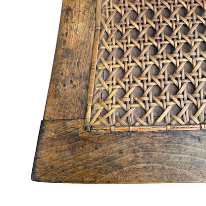 Detail of caned seat with hardwood frame and edge trim
