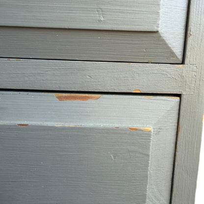 Side view of painted pine chest of drawers showing painted edge and corner chip