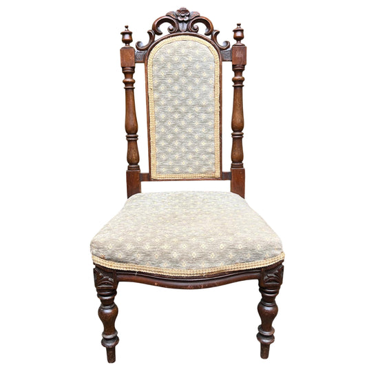 Victorian carved upholstered dining chair with floral crest and turned front legs