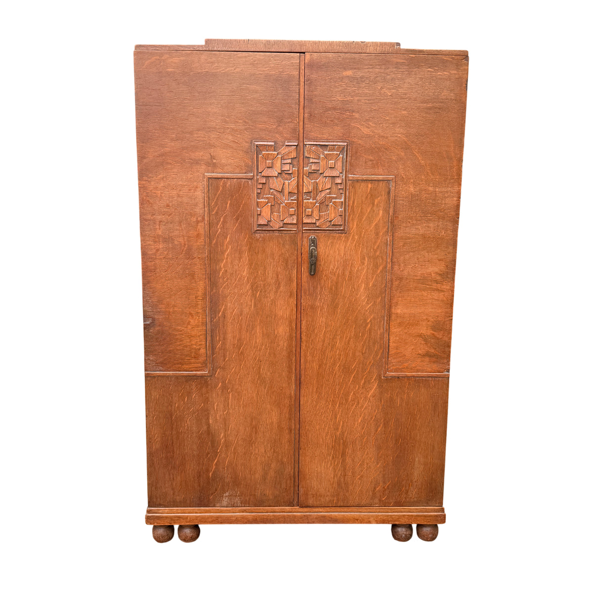 Small oak linen press with carved door panels and iron pull handle