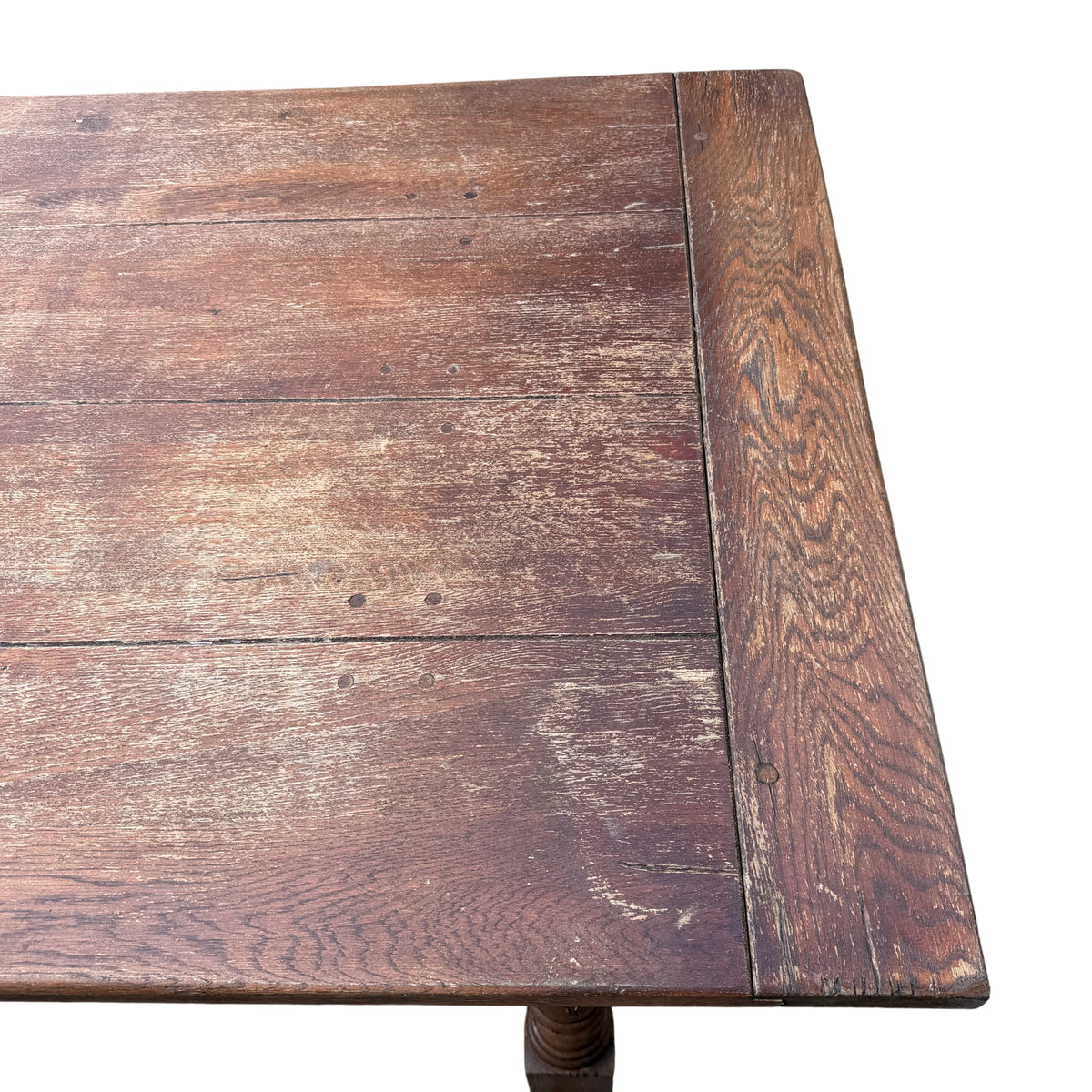 Close view of oak table top edge showing dovetail corner and surface grain