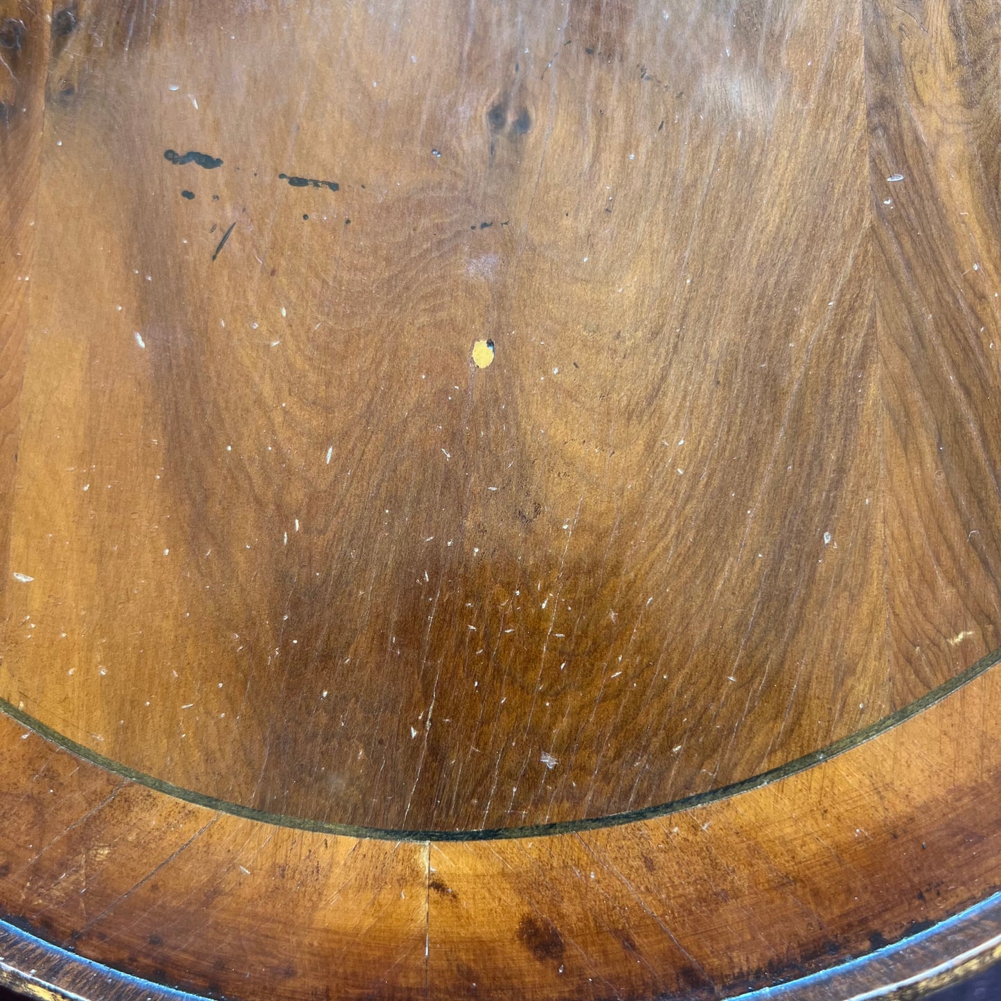 Profile of galleried rim with worn finish on an occasional table