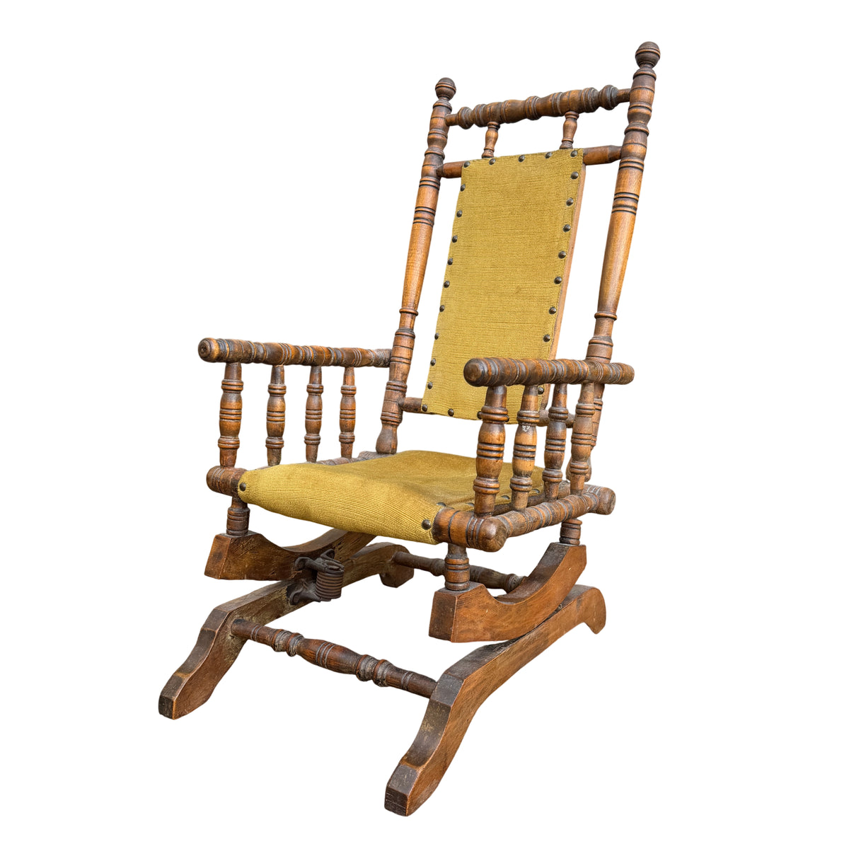Vintage child's turned spindle rocking chair with mustard-green upholstered seat and back, decorative tacks and sprung rocker base