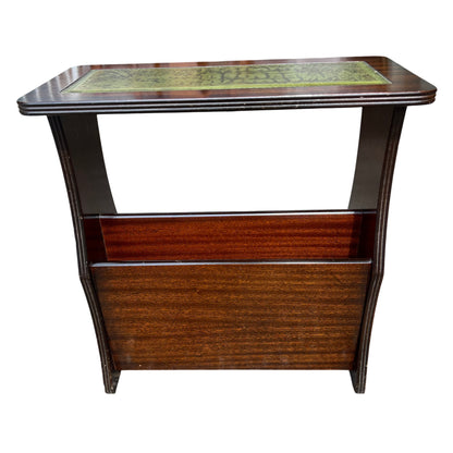 Top view showing green tooled leather panel and mahogany finish on a music cabinet