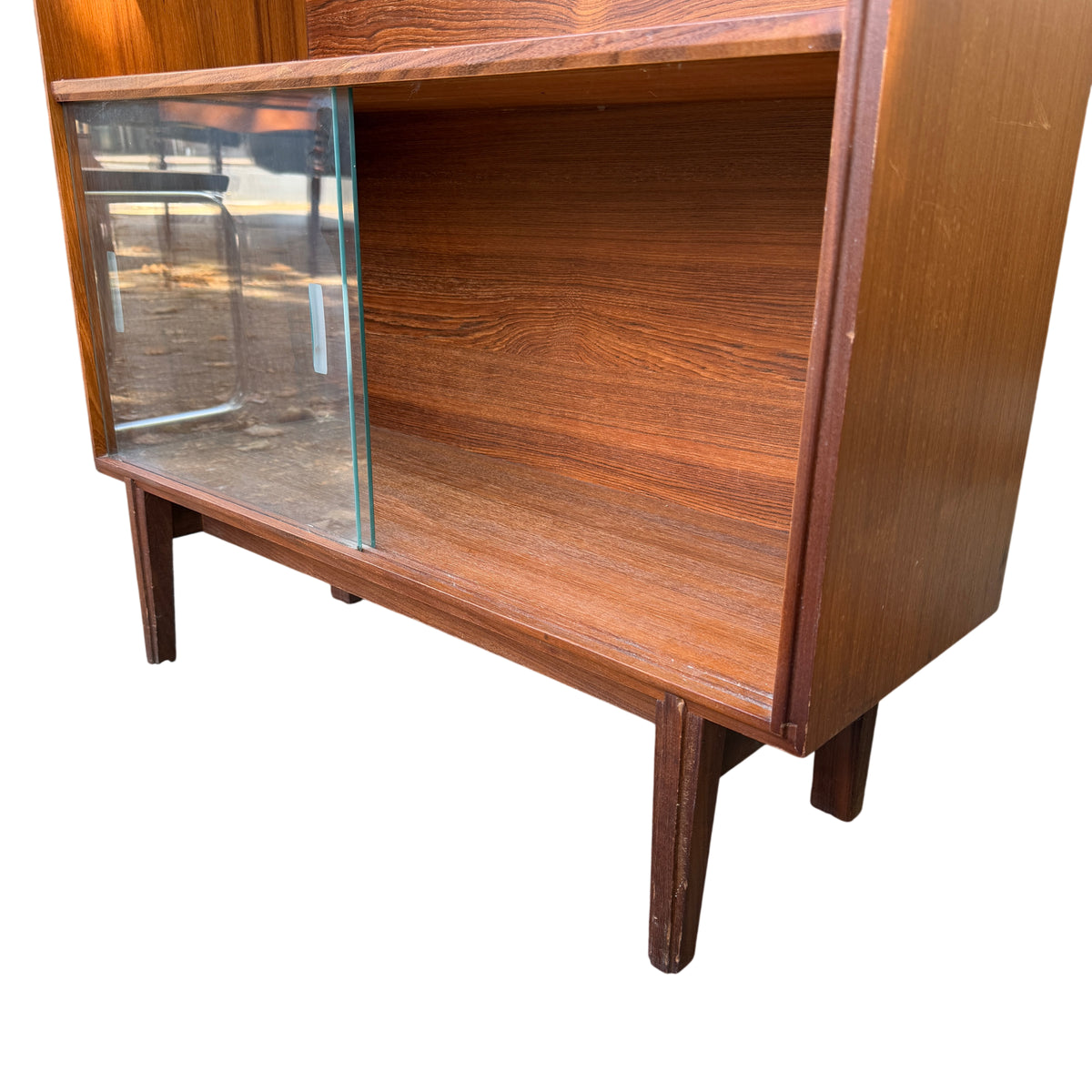 Vintage cabinet showing teak grain interior and adjustable shelf