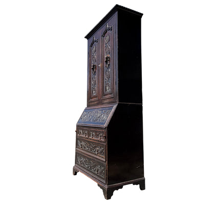 Close-up of carved fall-front secretaire panel on oak bureau
