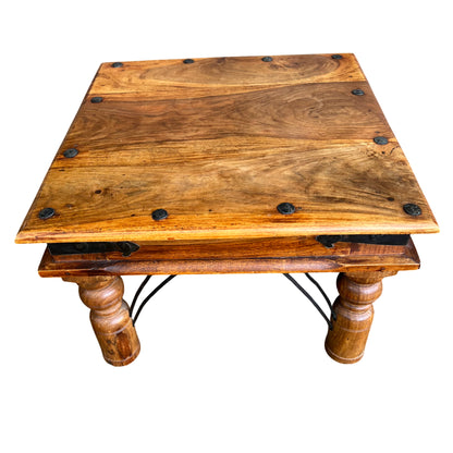 Low square hardwood occasional table with visible wood grain and iron brackets