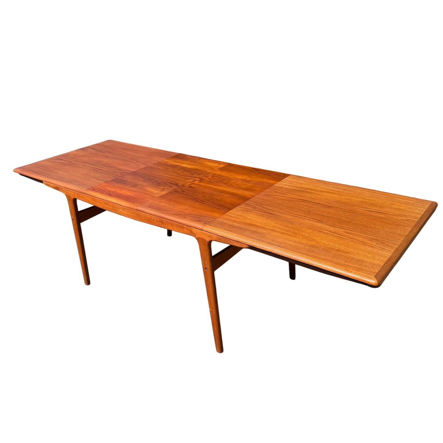 Side view of 1960s Danish teak dining table showing tapered legs and apron detail