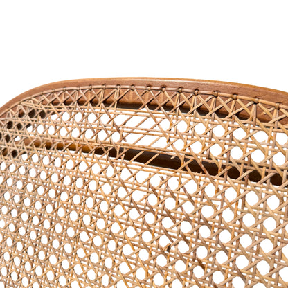 Side view showing curved bentwood arm and cane seat on vintage rocker