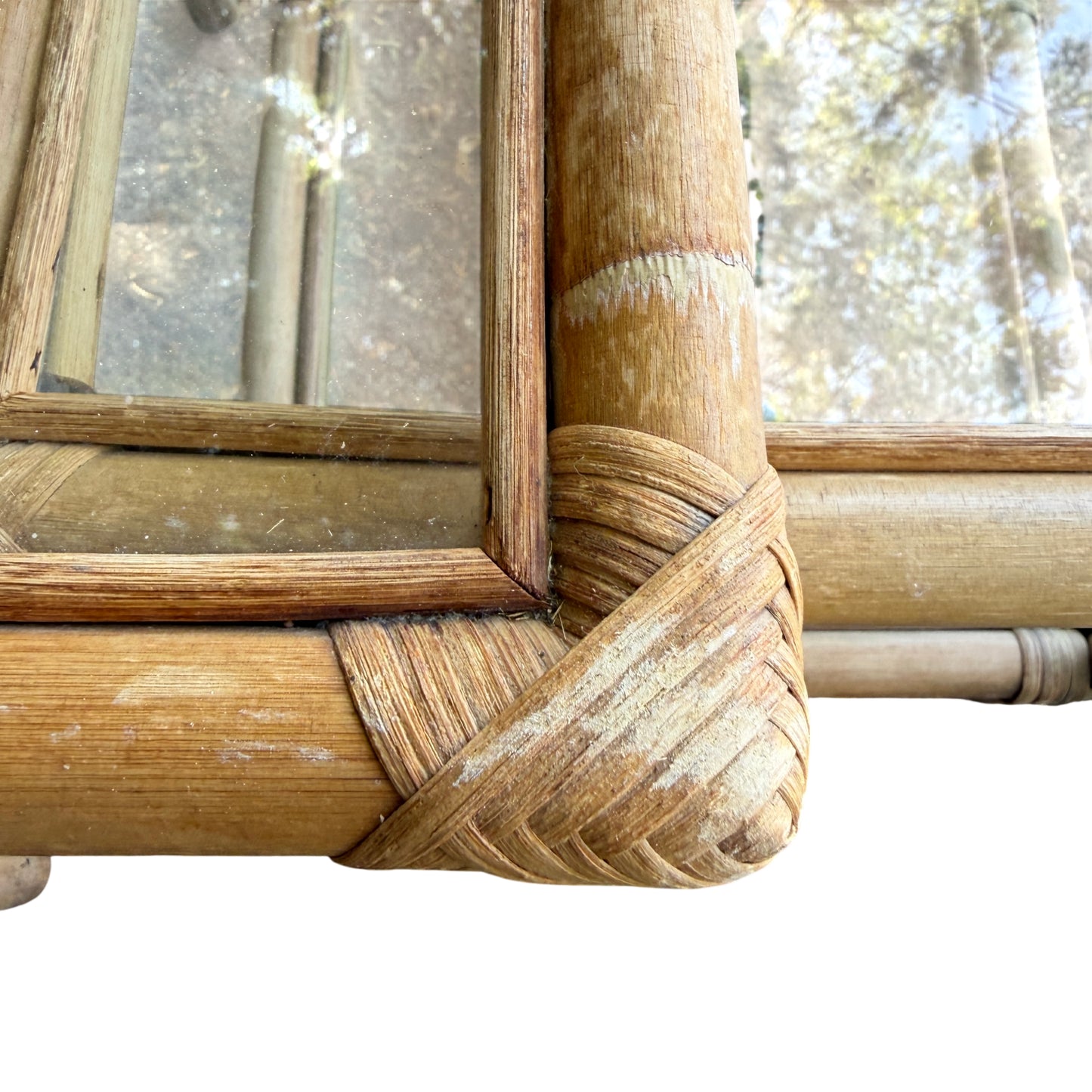Close-up of cane-wrapped corner joint on vintage rattan nesting table