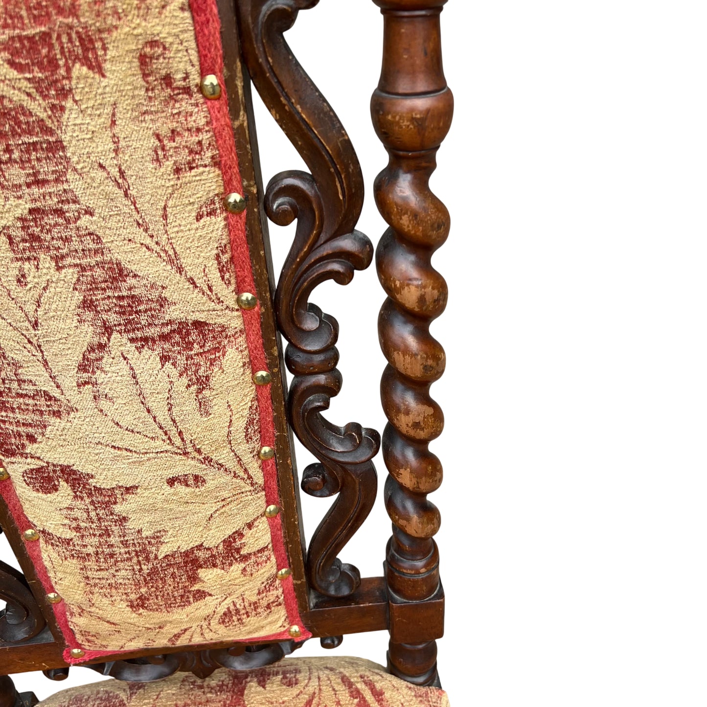 Close-up of carved scrolled top rail and upholstered tapestry back on walnut chair