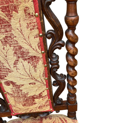 Close-up of carved scrolled top rail and upholstered tapestry back on walnut chair