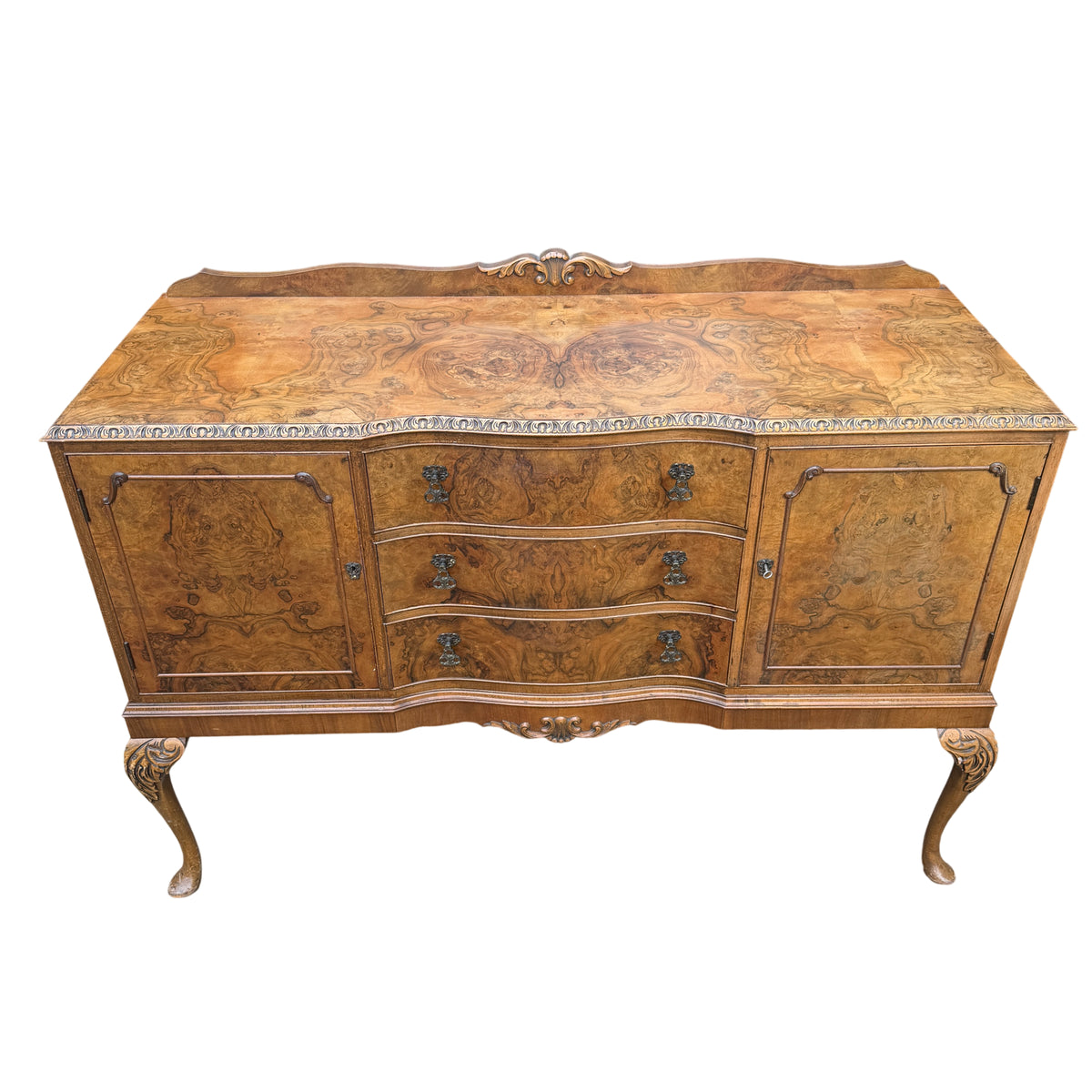 Close-up of burr walnut veneer pattern and moulded top edge of sideboard
