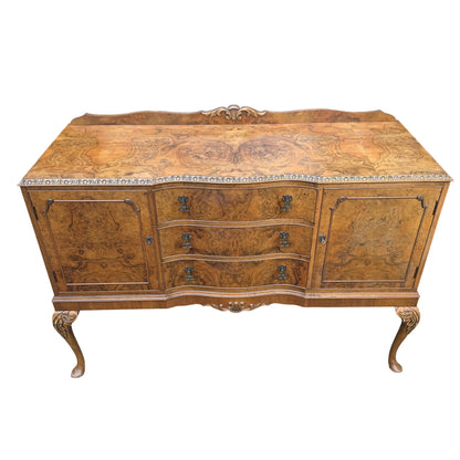 Close-up of burr walnut veneer pattern and moulded top edge of sideboard