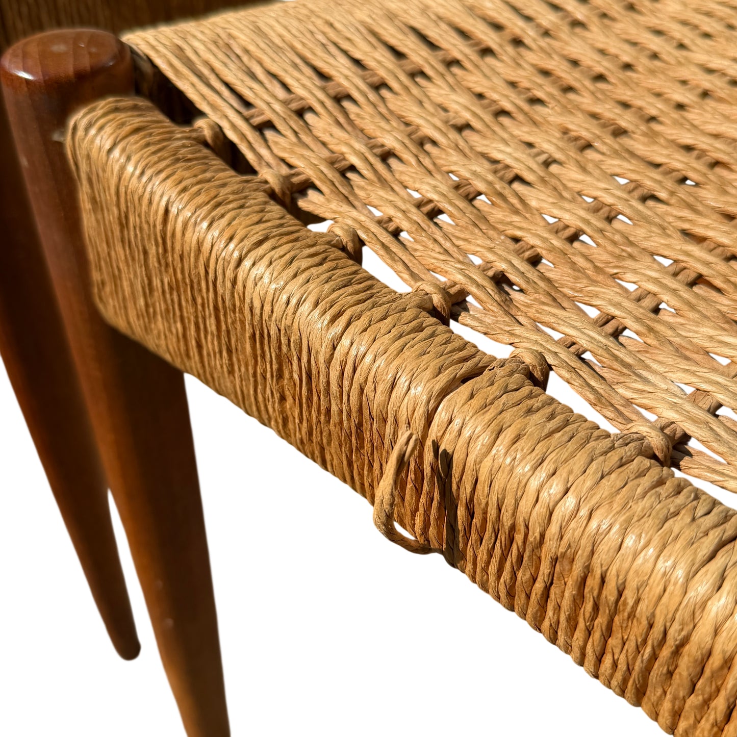 Detailed view of woven paper cord seat on a Danish modern dining chair