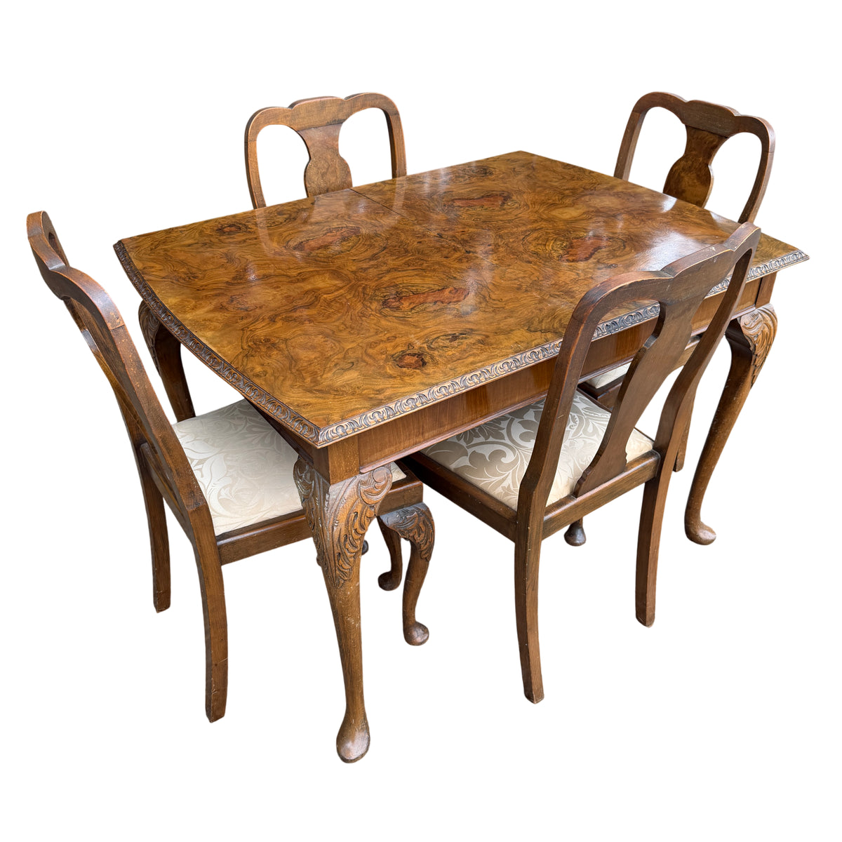 Vintage burr walnut extending dining table with removable central leaf and four matching carved chairs