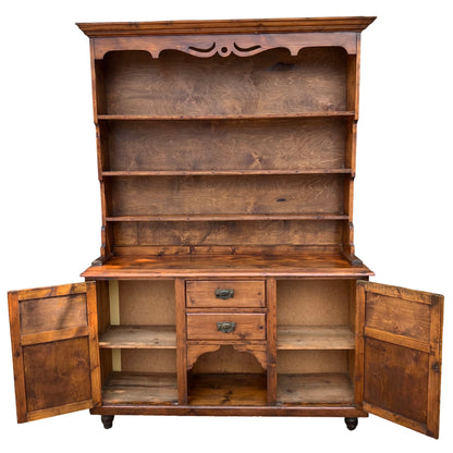 Open shelving on pine dresser with visible wood grain and shelf edge detail
