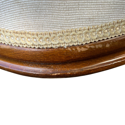 Upholstered bergère-style armchair in cream with wooden frame