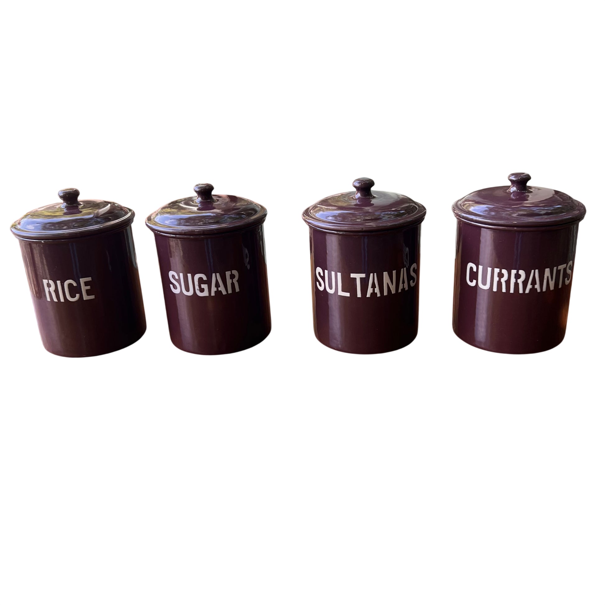 Set of four vintage purple enamel kitchen canisters labelled Rice Sugar Sultanas Currants on a wooden table