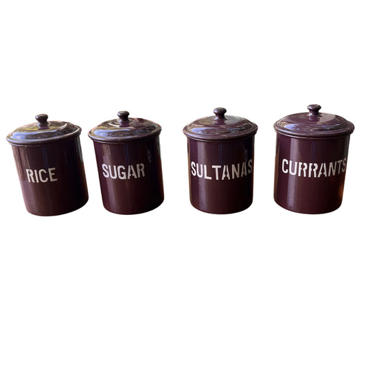 Set of four vintage purple enamel kitchen canisters labelled Rice Sugar Sultanas Currants on a wooden table
