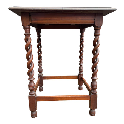 Front view of oak-style hall table showing barley-twist legs and rectangular stretcher base