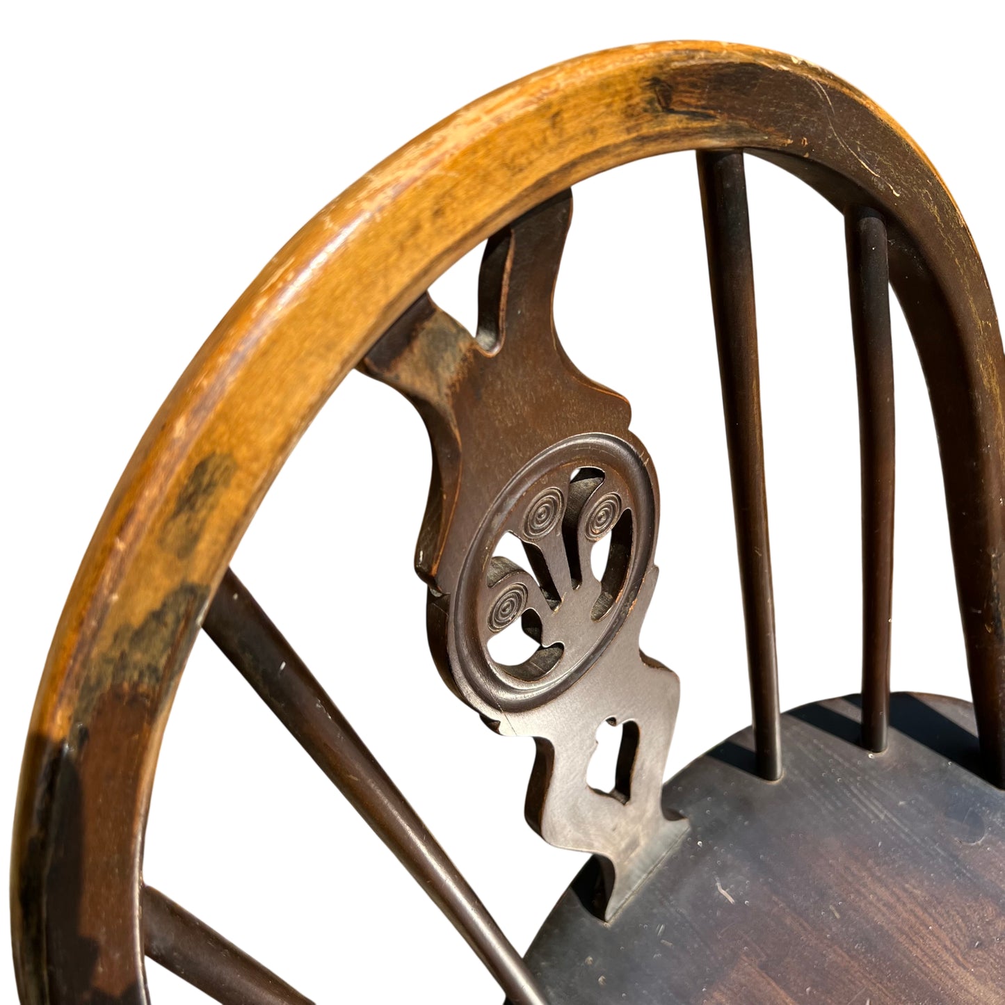 Rear view of chair showing top rail and spindle back in dark stained finish