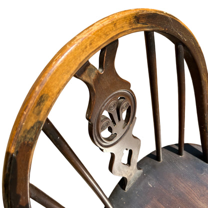Rear view of chair showing top rail and spindle back in dark stained finish