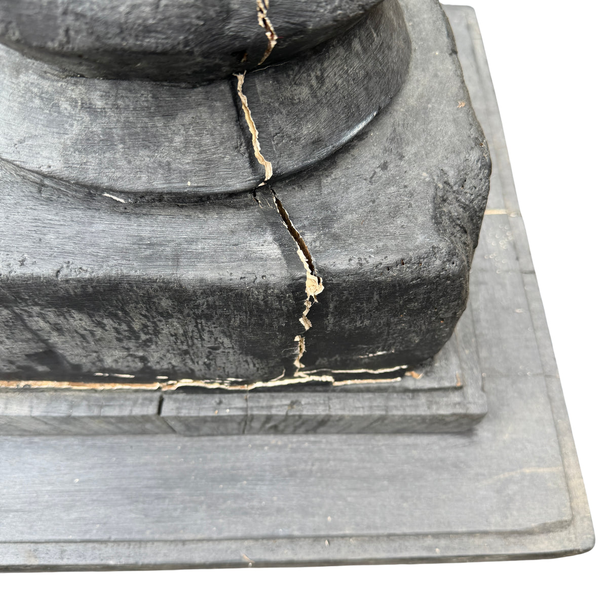 Base plinth showing cracks and age wear on reclaimed timber pedestal