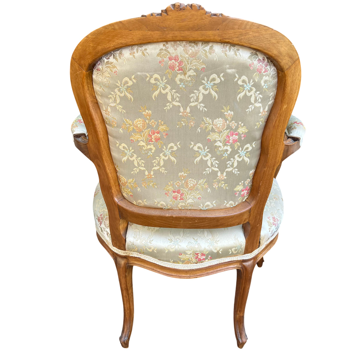 Seat and back upholstery detail showing pale floral woven fabric on bergère chair