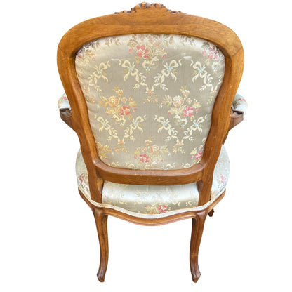 Seat and back upholstery detail showing pale floral woven fabric on bergère chair