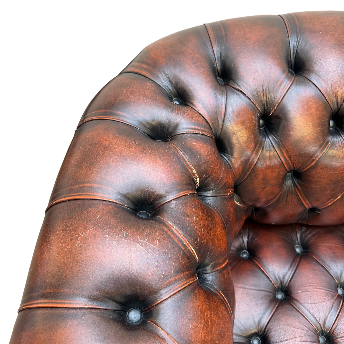 Lower front of Chesterfield sofa with studded trim and buttoned base