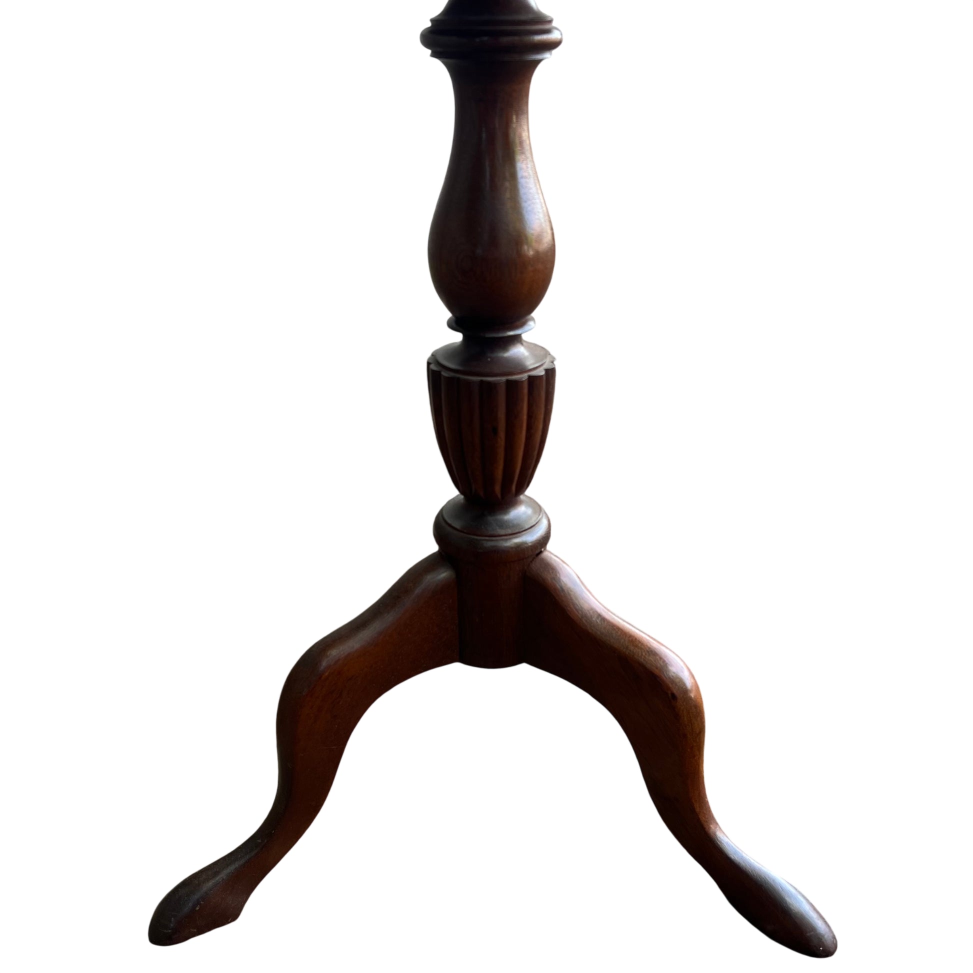 Close up of red leather tabletop with visible wear and tooling on Victorian pedestal table