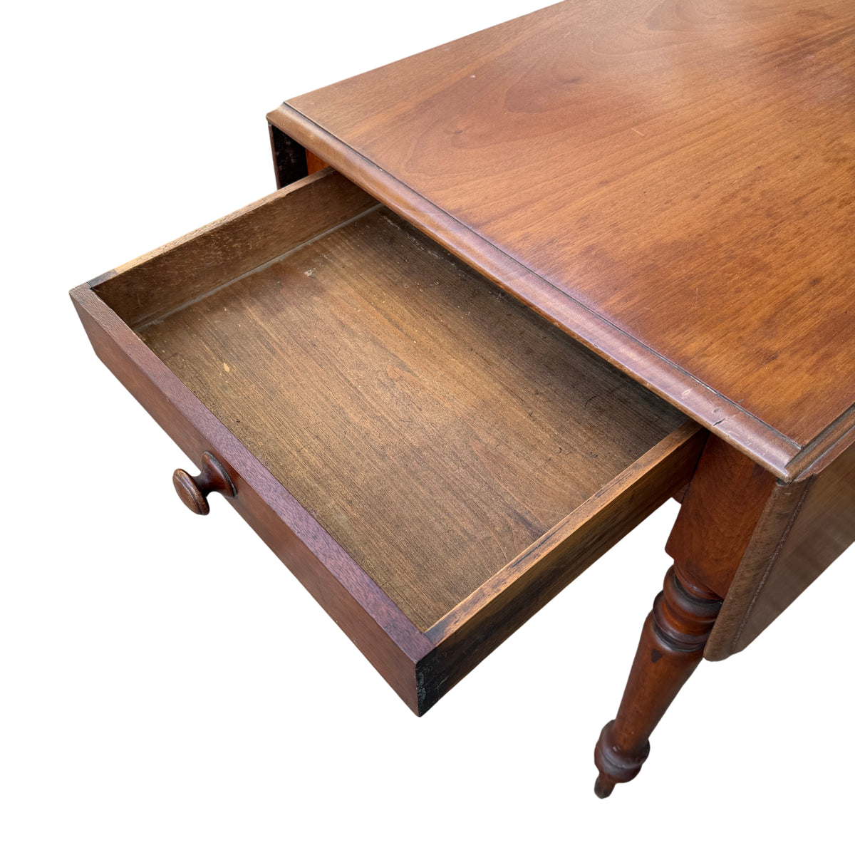 Side view of compact drop-leaf dining table with turned legs and apron