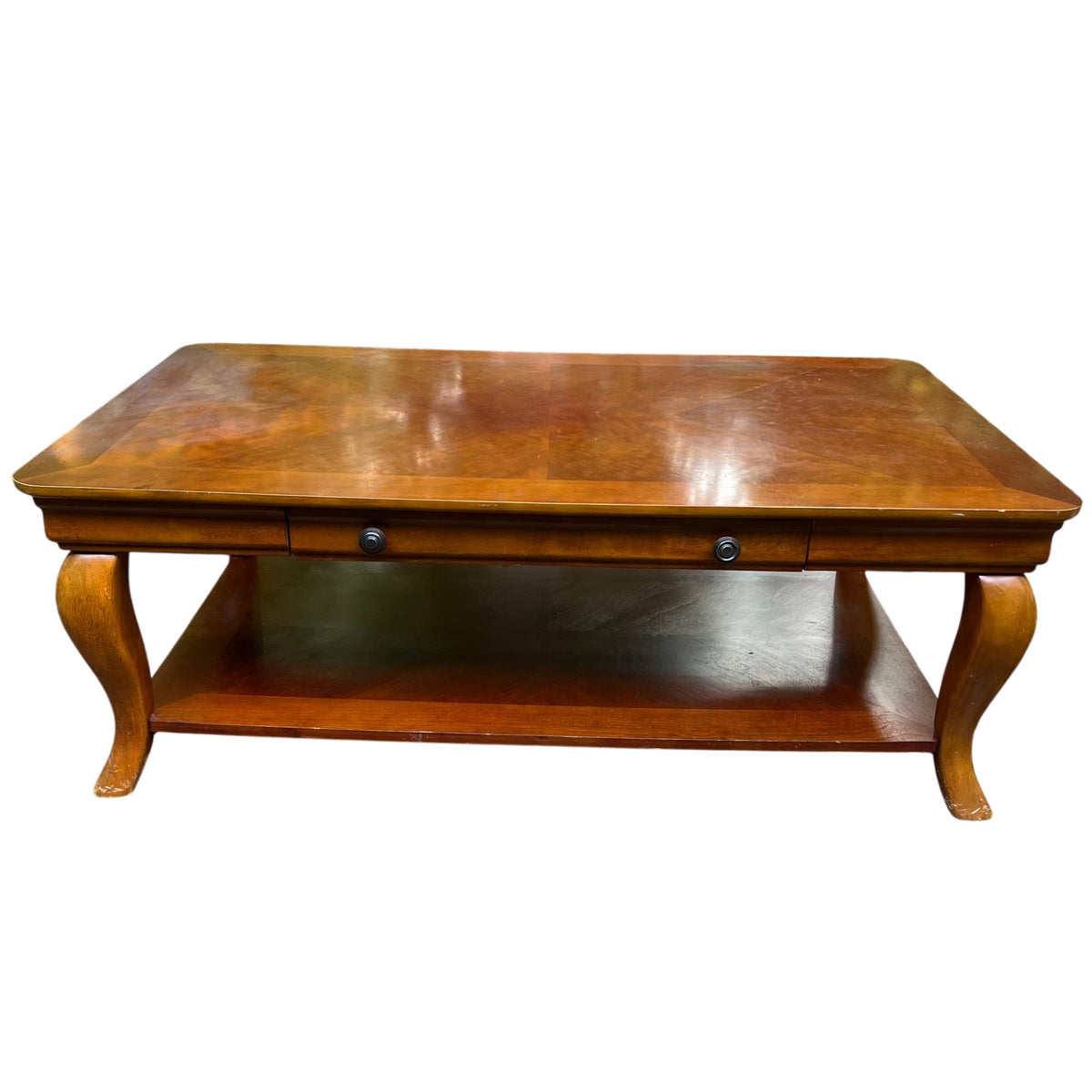 Lower shelf surface and turned leg detail on a vintage coffee table