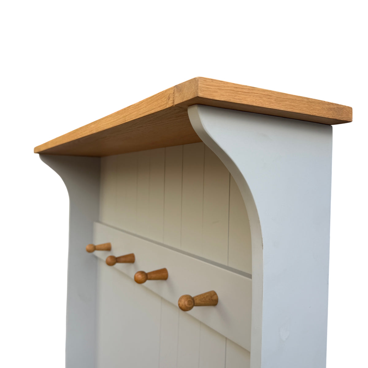 Side view showing painted curved side panel and oak top of storage bench