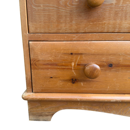 Top surface of pine chest showing knotty pine boards and finish wear