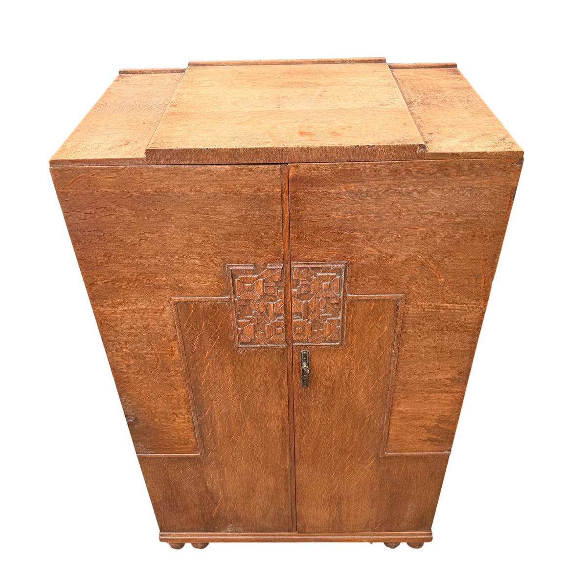 Front view carved doors on Art Deco oak cupboard with Vesper Furniture badge