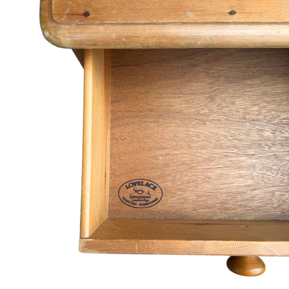 Close up of turned wooden knob on a pine chest drawer