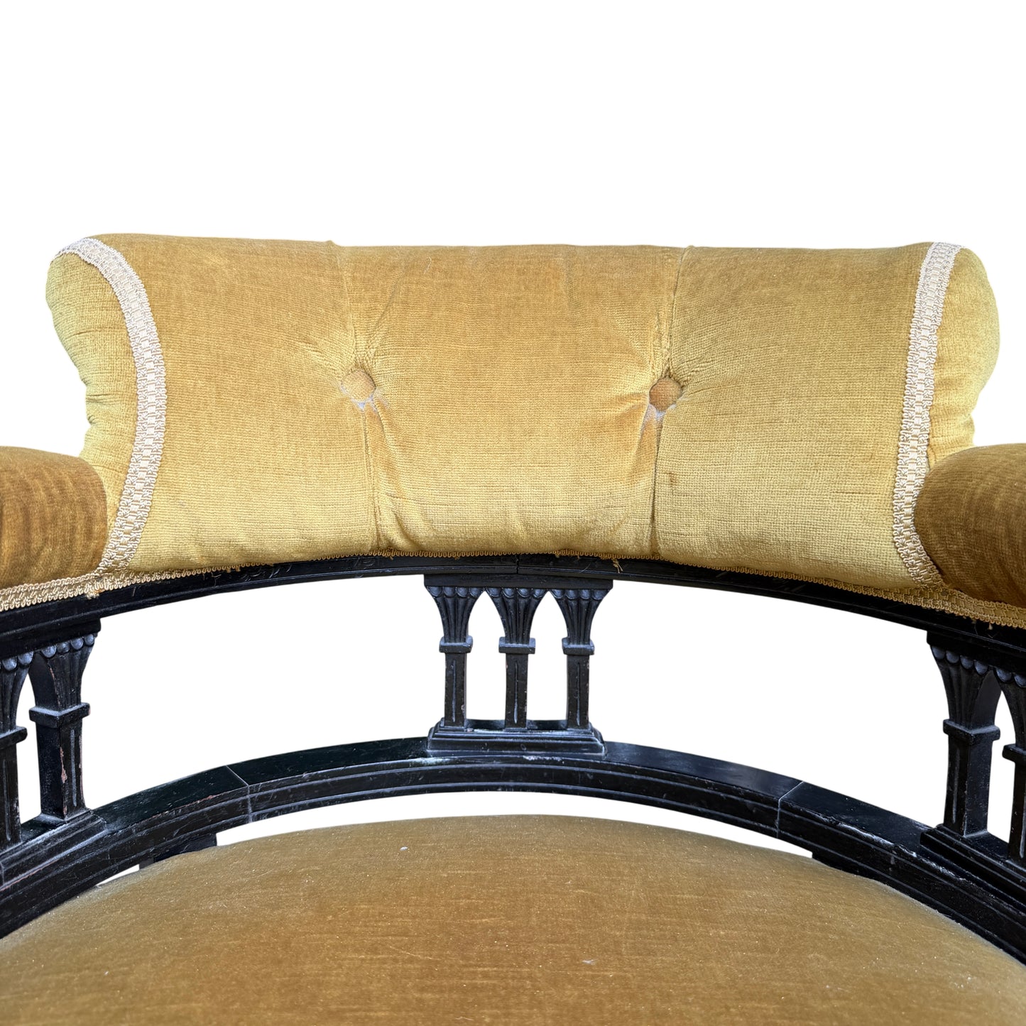 Seat detail of mustard velvet upholstered armchair with slightly compressed cushion surface