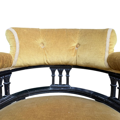 Seat detail of mustard velvet upholstered armchair with slightly compressed cushion surface