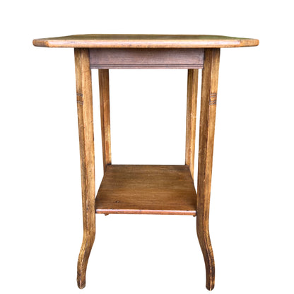Side view of three-tier oak occasional table with narrow shelves and vertical supports