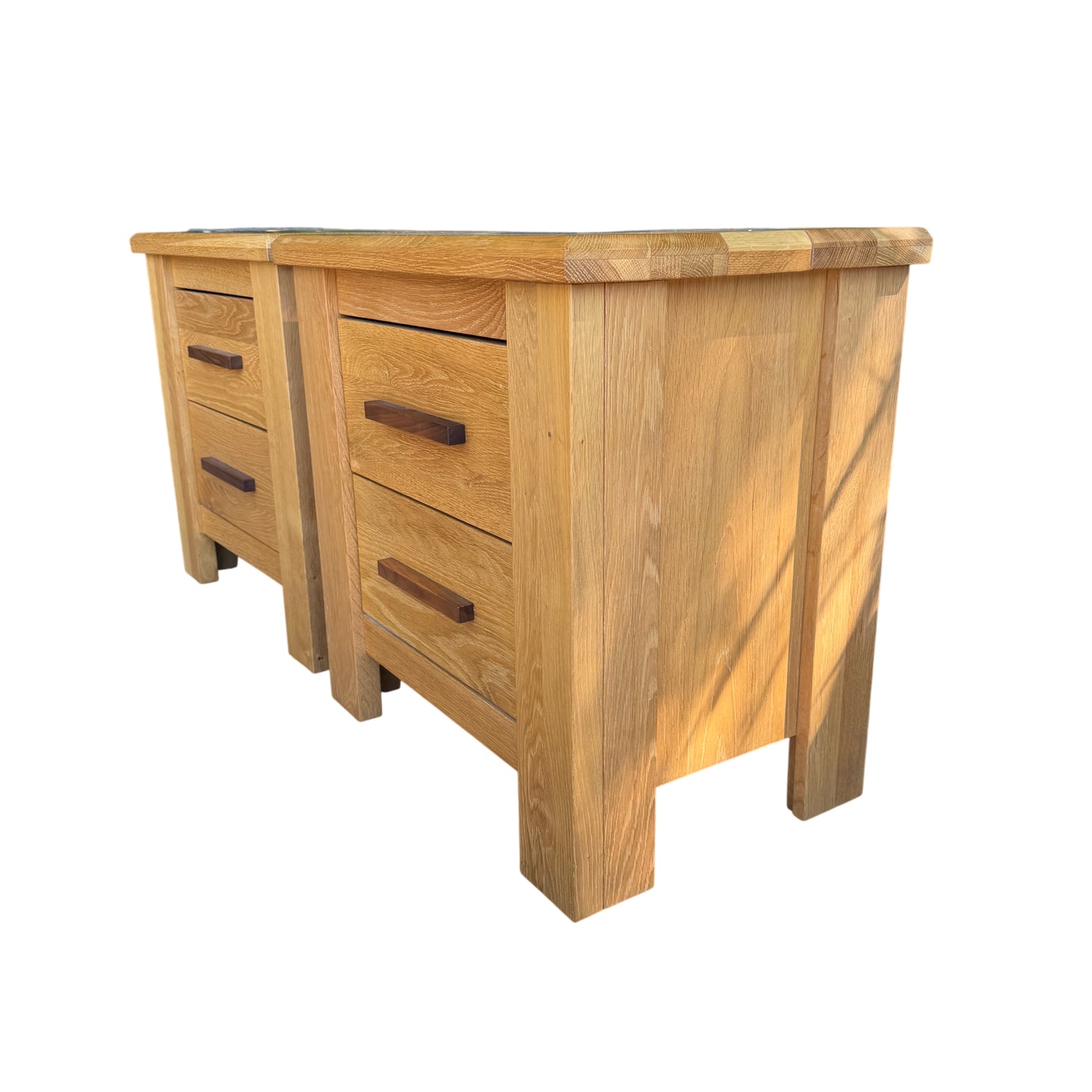 Two bedside cabinets with oak grain visible and darker handles inset