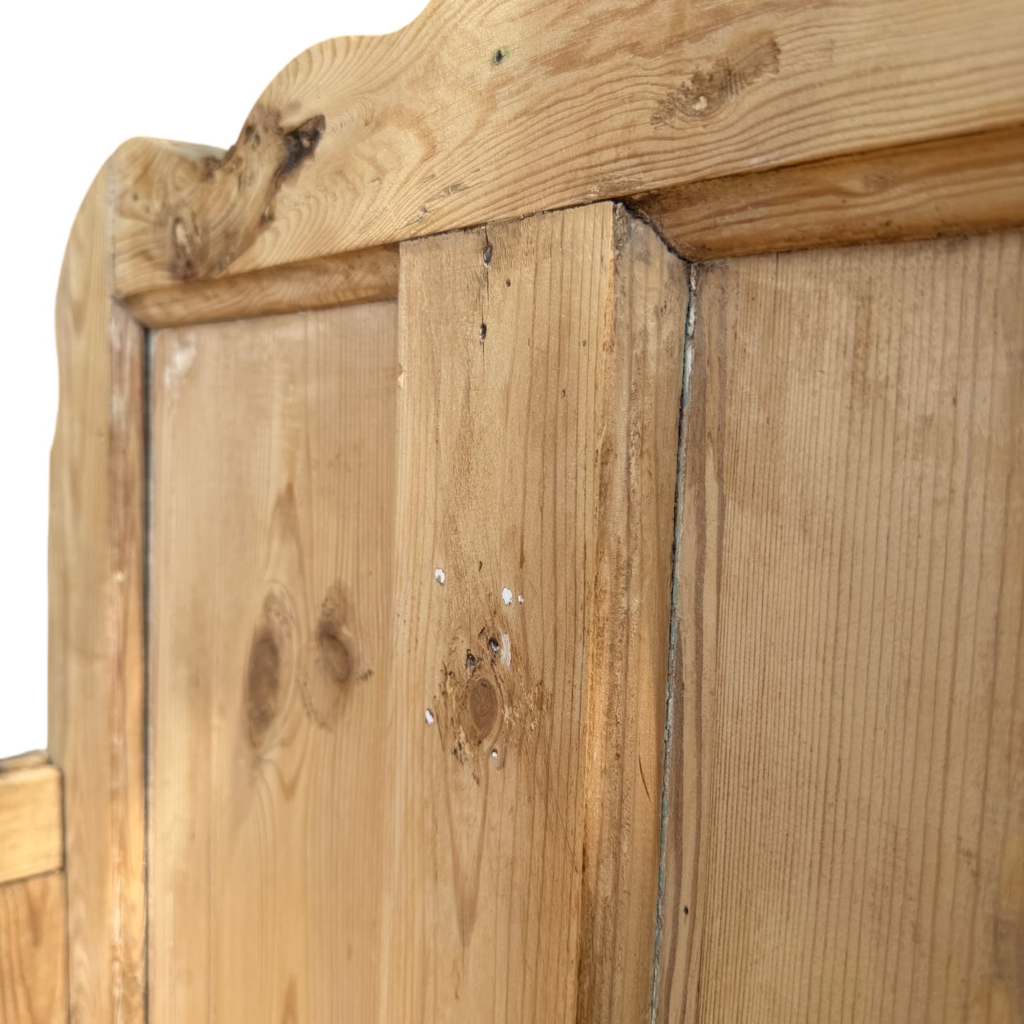 Detail of worn feet and lower moulding on reclaimed pine settle