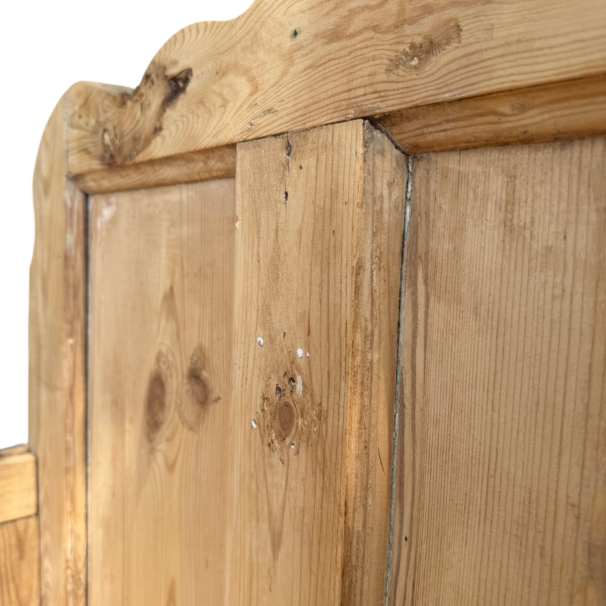 Detail of worn feet and lower moulding on reclaimed pine settle