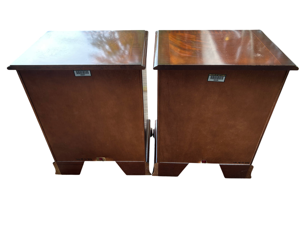 Side view of mahogany bedside cabinet with moulded top and scrolled plinth base