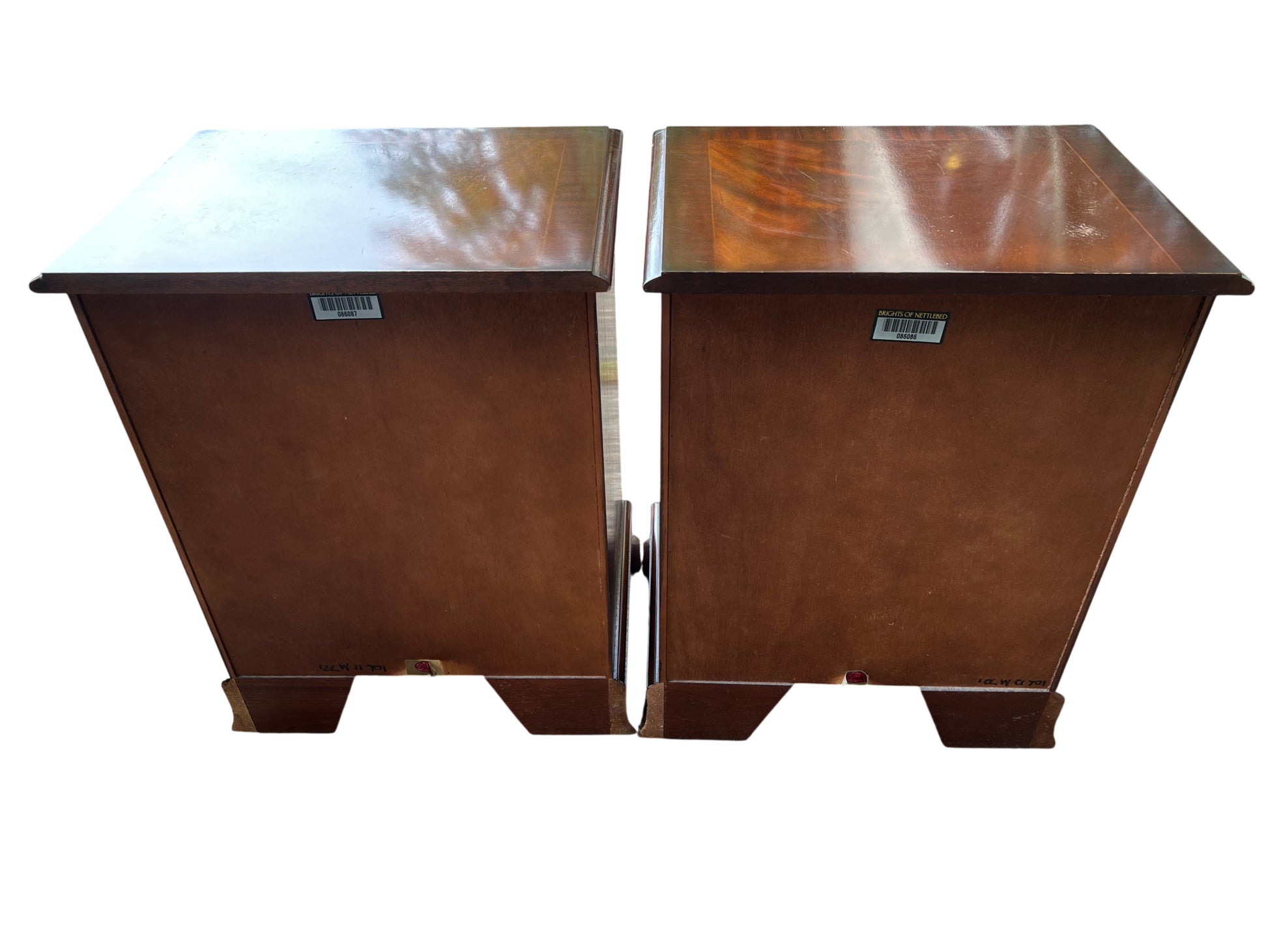 Side view of mahogany bedside cabinet with moulded top and scrolled plinth base
