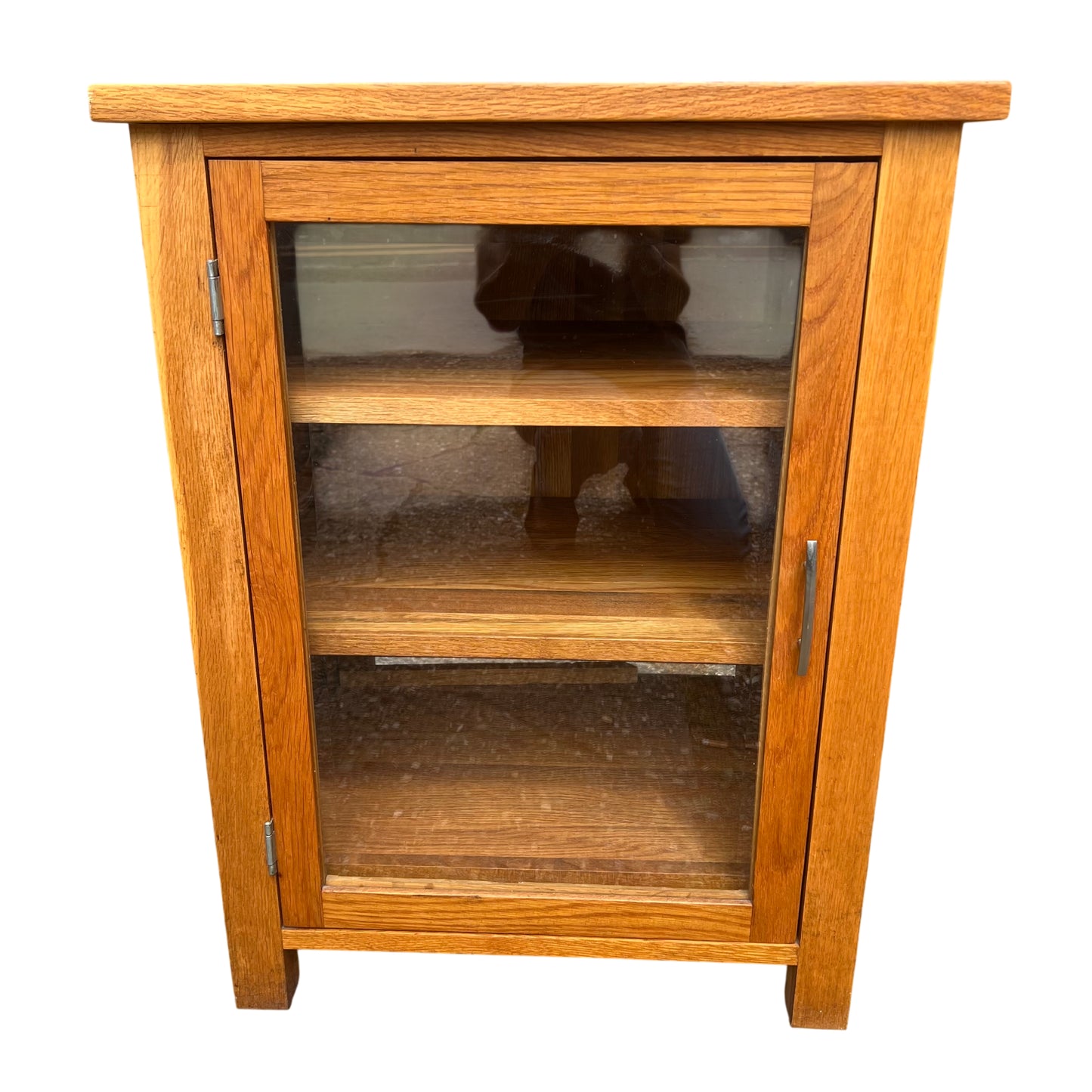 Oak glazed display cabinet with glass front door, two internal shelves and metal handle