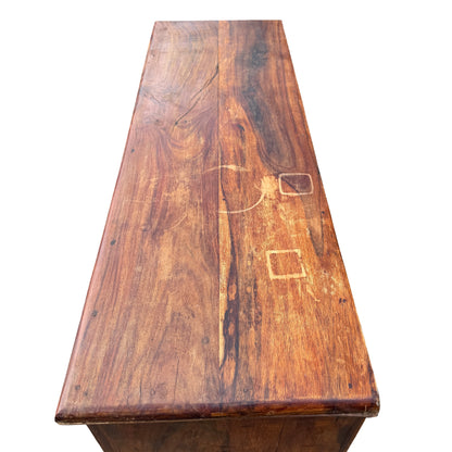 Side view showing wood grain and a long scratch on the side of the chest of drawers