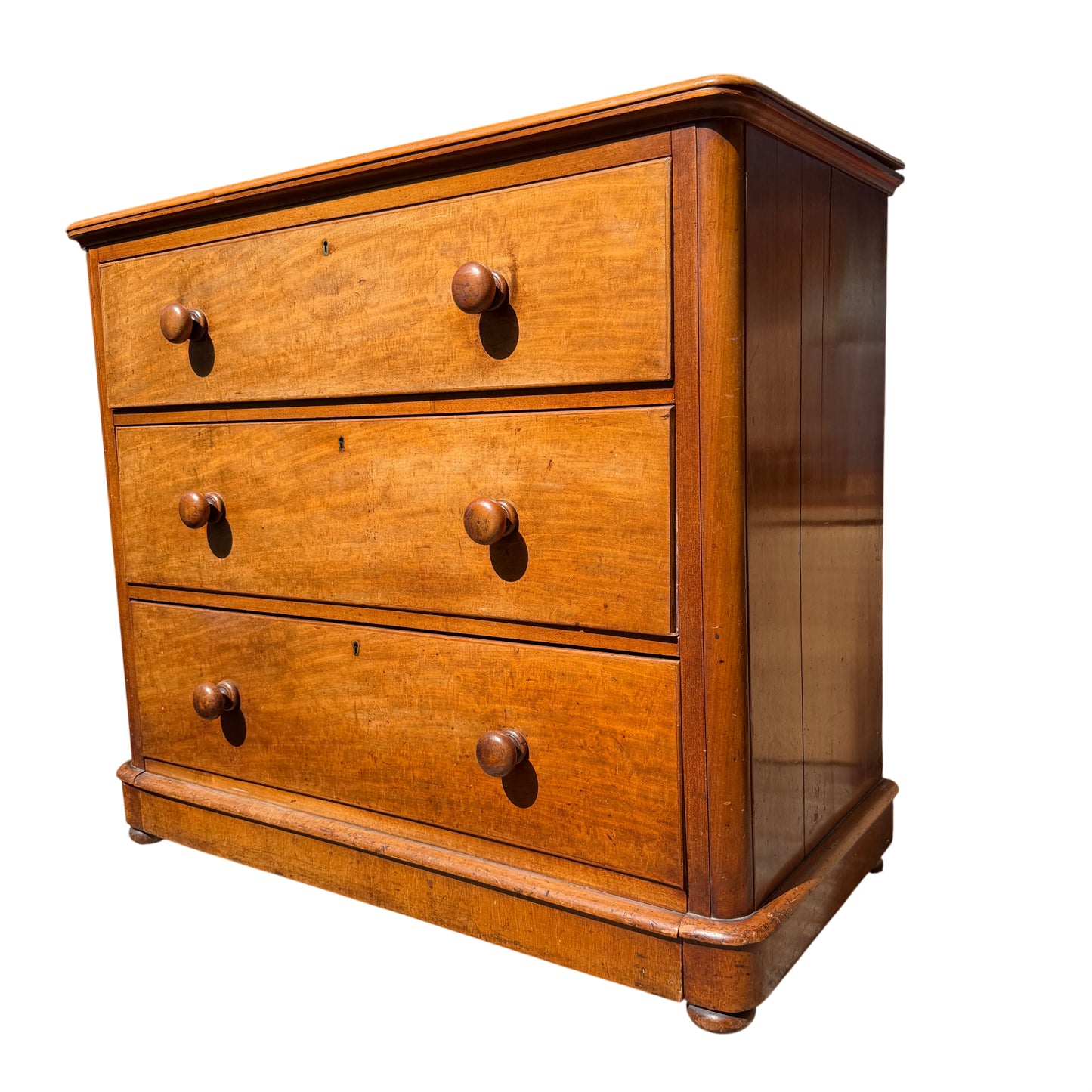 Close-up of the top drawer and turned wooden knobs on pine chest