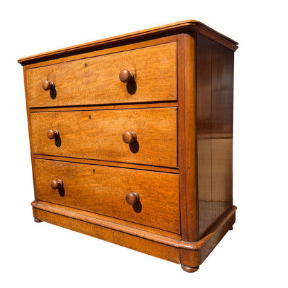 Close-up of the top drawer and turned wooden knobs on pine chest
